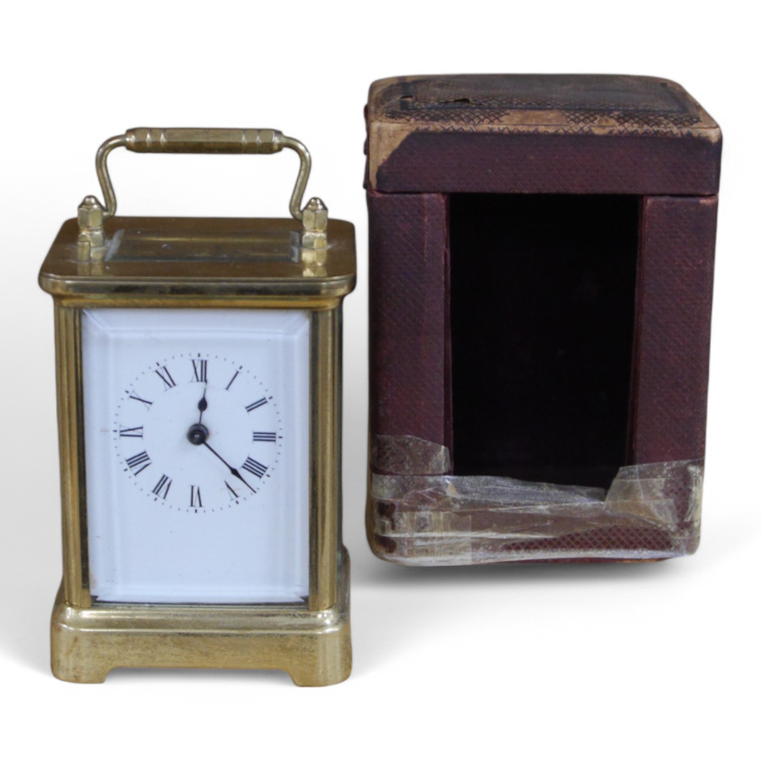 A cased carriage clock, 12cm high including handle. Condition - cased taped at base, clock unknown if it works.